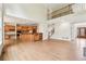 Open-concept living area with hardwood floors, fireplace, kitchen, and staircase at 4508 Meadow Vista Trce, Lithonia, GA 30038