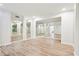Bright living room features mirrors and wood-look flooring at 4508 Meadow Vista Trce, Lithonia, GA 30038