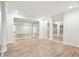 Spacious living room with multiple mirrors and wood-look flooring at 4508 Meadow Vista Trce, Lithonia, GA 30038