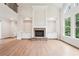 Spacious living room with hardwood floors, built-in cabinets, fireplace, and tall windows at 4508 Meadow Vista Trce, Lithonia, GA 30038
