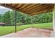 Back patio area with concrete base below a wooden deck, overlooking the backyard and trees at 4508 Meadow Vista Trce, Lithonia, GA 30038