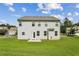 Spacious backyard featuring well maintained grass, light gray siding, and a small patio at 98 Concord Pl, Hiram, GA 30141