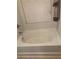 A white bathtub sits near a window with blinds and a towel at 98 Concord Pl, Hiram, GA 30141