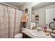 A bathroom with a patterned shower curtain and a large mirror above the sink at 98 Concord Pl, Hiram, GA 30141