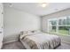 Bedroom with carpeted floor, light gray walls and a sunny window with green tree views at 98 Concord Pl, Hiram, GA 30141