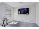 This bedroom has carpet, a window, and a TV hanging on the wall at 98 Concord Pl, Hiram, GA 30141