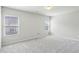 Bright bedroom with light gray walls, carpet, and natural light from two windows at 98 Concord Pl, Hiram, GA 30141