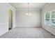 Large formal dining room features carpet, a chandelier, and wainscoting at 98 Concord Pl, Hiram, GA 30141