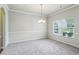 Large formal dining room features carpet, a chandelier, and wainscoting at 98 Concord Pl, Hiram, GA 30141