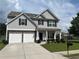 Charming two-story home featuring a two-car garage and landscaped front yard at 98 Concord Pl, Hiram, GA 30141