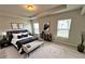 Elegant bedroom featuring a king bed, neutral decor, and plenty of natural light from the surrounding windows at 98 Concord Pl, Hiram, GA 30141