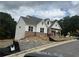 New construction with white siding, brick accents, and an attached two-car garage at 202 Willow St, Canton, GA 30114