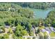 Aerial view of the lakeside homes nestled among lush greenery and the lake's serene waterways at 2155 Cove Trl, Cumming, GA 30041