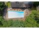 Aerial view of a community pool surrounded by mature trees and seating for relaxation at 2155 Cove Trl, Cumming, GA 30041