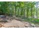 Backyard outdoor dining area offers lovely lakeside views, perfect for enjoying meals surrounded by nature at 2155 Cove Trl, Cumming, GA 30041