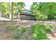 View of the home and lush backyard, highlighting the natural surroundings and outdoor living spaces at 2155 Cove Trl, Cumming, GA 30041