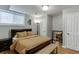 Cozy bedroom with wood floors, a queen bed and a mirror at 2155 Cove Trl, Cumming, GA 30041