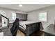 Cozy bedroom with hardwood floors, light gray walls, a queen bed, and built-in storage, perfect for relaxing or gaming at 2155 Cove Trl, Cumming, GA 30041