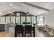 Sun-filled dining room with stylish decor, hardwood floors, an oversized light fixture, and views of the backyard at 2155 Cove Trl, Cumming, GA 30041