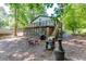 Charming backyard showcasing the deck, outdoor seating, sunroom, and the home's architectural details at 2155 Cove Trl, Cumming, GA 30041