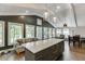Open concept kitchen with eat-in area boasts lots of natural light, a large island and seating, and a modern design at 2155 Cove Trl, Cumming, GA 30041