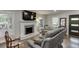 The spacious living room boasts hardwood floors, a fireplace, and a large window offering plenty of natural light at 2155 Cove Trl, Cumming, GA 30041
