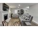 A beautifully appointed living room with a cozy fireplace, hardwood floors, and ample natural light from the window at 2155 Cove Trl, Cumming, GA 30041