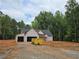 Exterior view of home under construction with protective wrap and a dumpster nearby at 354 Spruill Bridge Rd, Temple, GA 30179