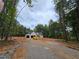 Scenic view of a new home's construction from a distance along a partially completed driveway at 354 Spruill Bridge Rd, Temple, GA 30179