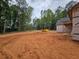 Spacious building lot with the frame of a new home, surrounded by mature trees at 354 Spruill Bridge Rd, Temple, GA 30179