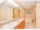 Well-lit bathroom with double sink vanity, garden tub, and tiled floor at 4150 Sterling Pointe Dr, Douglasville, GA 30135