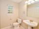 Bathroom with toilet, sink, and large mirror, all brightly lit at 4150 Sterling Pointe Dr, Douglasville, GA 30135