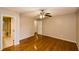 Bedroom with hardwood floors, ceiling fan, and attached bathroom at 4150 Sterling Pointe Dr, Douglasville, GA 30135