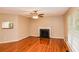 Cozy living room featuring hardwood floors, a fireplace, and natural light, creating a warm and inviting atmosphere at 4150 Sterling Pointe Dr, Douglasville, GA 30135