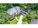 An aerial view of a two-story home with a long driveway and lush landscaping at 837 Pine Ridge Dr, Lawrenceville, GA 30043