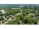 Aerial view shows a property and its surrounding area with dense trees in a suburban neighborhood at 837 Pine Ridge Dr, Lawrenceville, GA 30043
