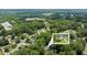 Aerial view shows a property and its surrounding area with dense trees in a suburban neighborhood at 837 Pine Ridge Dr, Lawrenceville, GA 30043