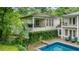 Backyard view of house with swimming pool and outdoor seating area, perfect for entertaining and relaxation at 837 Pine Ridge Dr, Lawrenceville, GA 30043