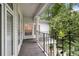 View of the side covered balcony that runs the length of the home, with white pillars and metal railing at 837 Pine Ridge Dr, Lawrenceville, GA 30043