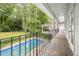 Long, covered balcony overlooking the in-ground pool and lush green backyard at 837 Pine Ridge Dr, Lawrenceville, GA 30043