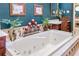 Bathroom featuring a tub with jets, vintage fixtures, and a wooden vanity at 837 Pine Ridge Dr, Lawrenceville, GA 30043