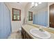 Neutral bathroom with a blue shower curtain, a window, and wallpapered walls at 837 Pine Ridge Dr, Lawrenceville, GA 30043