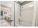 View of a bathroom with a tub-shower and a mirrored vanity in the background at 837 Pine Ridge Dr, Lawrenceville, GA 30043