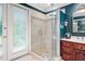 Bathroom featuring a glass shower, double doors, and a vanity with storage at 837 Pine Ridge Dr, Lawrenceville, GA 30043