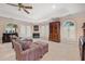 Bedroom featuring seating area, fireplace, french doors, tray ceilings, and light-colored walls at 837 Pine Ridge Dr, Lawrenceville, GA 30043