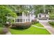Traditional white two-story home with black shutters, a front porch, and a manicured lawn with mature landscaping at 837 Pine Ridge Dr, Lawrenceville, GA 30043