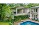 Aerial view of the home's rear exterior with a covered patio, swimming pool, and lush greenery at 837 Pine Ridge Dr, Lawrenceville, GA 30043