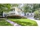 Two-story home with white siding, black shutters, and a well-manicured front yard and landscaping at 837 Pine Ridge Dr, Lawrenceville, GA 30043