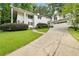 View of the front exterior with a circular driveway and well-manicured front lawn of this two-story home at 837 Pine Ridge Dr, Lawrenceville, GA 30043