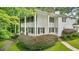 Traditional home with a covered front porch, black shutters, columns, and lush landscaping at 837 Pine Ridge Dr, Lawrenceville, GA 30043